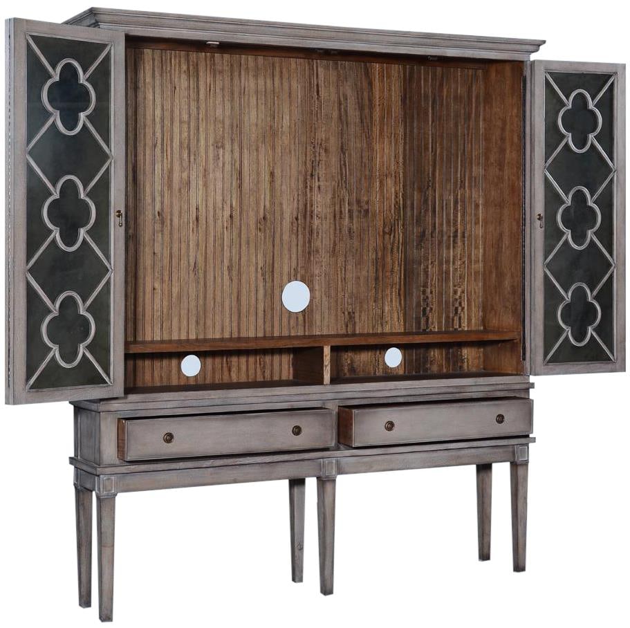 Wilcox French Country TV Cabinet with Bi-Fold Doors Greige Finish: Wilcox French Country TV Cabinet with Bi-Fold Doors Greige Finish Introducing the Elegant Wilcox TV Cabinet, a stunning piece crafted in a vintage style that adds a touch of sophistication to any livi