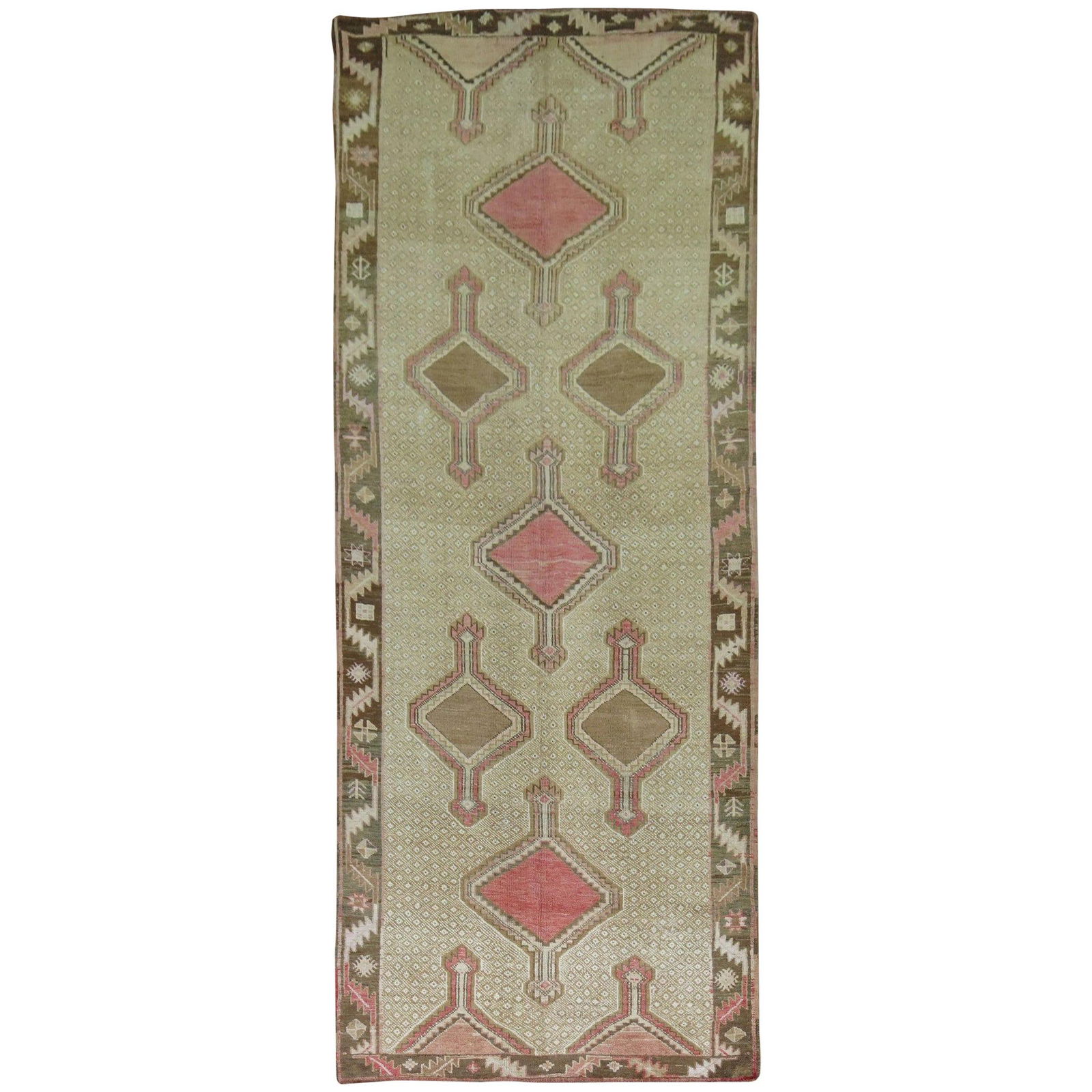4'7" x 12'5" Wool Turkish Tribal Gallery Rug with Pink Accents Circa 1940: 4'7" x 12'5" Wool Turkish Tribal Gallery Rug with Pink Accents Circa 1940 This vintage Turkish gallery rug from the mid-20th century features a tribal design with pink and brown medallions on a khaki