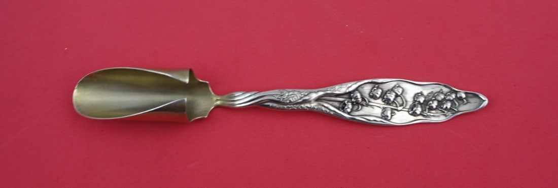 Whiting Sterling Silver Lily of the Valley Cheese Scoop 8 1/8": Whiting Sterling Silver Lily of the Valley Cheese Scoop 8 1/8" This exquisite cheese scoop from the renowned Whiting company features the elegant Lily of the Valley pattern. Made from high-quality ste