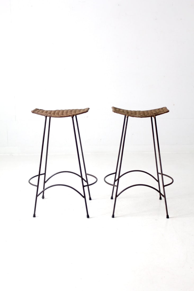 Mid-Century Arthur Umanoff Style Bar Stools Pair with Wicker Seats: Mid-Century Arthur Umanoff Style Bar Stools Pair with Wicker Seats This pair of mid-20th century bar stools embodies the distinctive style of Arthur Umanoff. Each stool features sleek iron hairpin leg
