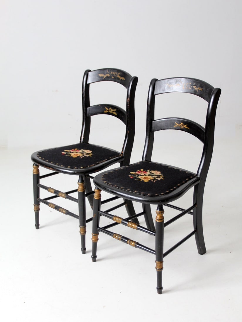 Antique Hitchcock Style Accent Chairs Pair with Floral Needlepoint: Antique Hitchcock Style Accent Chairs Pair with Floral Needlepoint This pair of antique accent chairs showcases a classic Hitchcock style, featuring a striking black finish adorned with elegant gold s