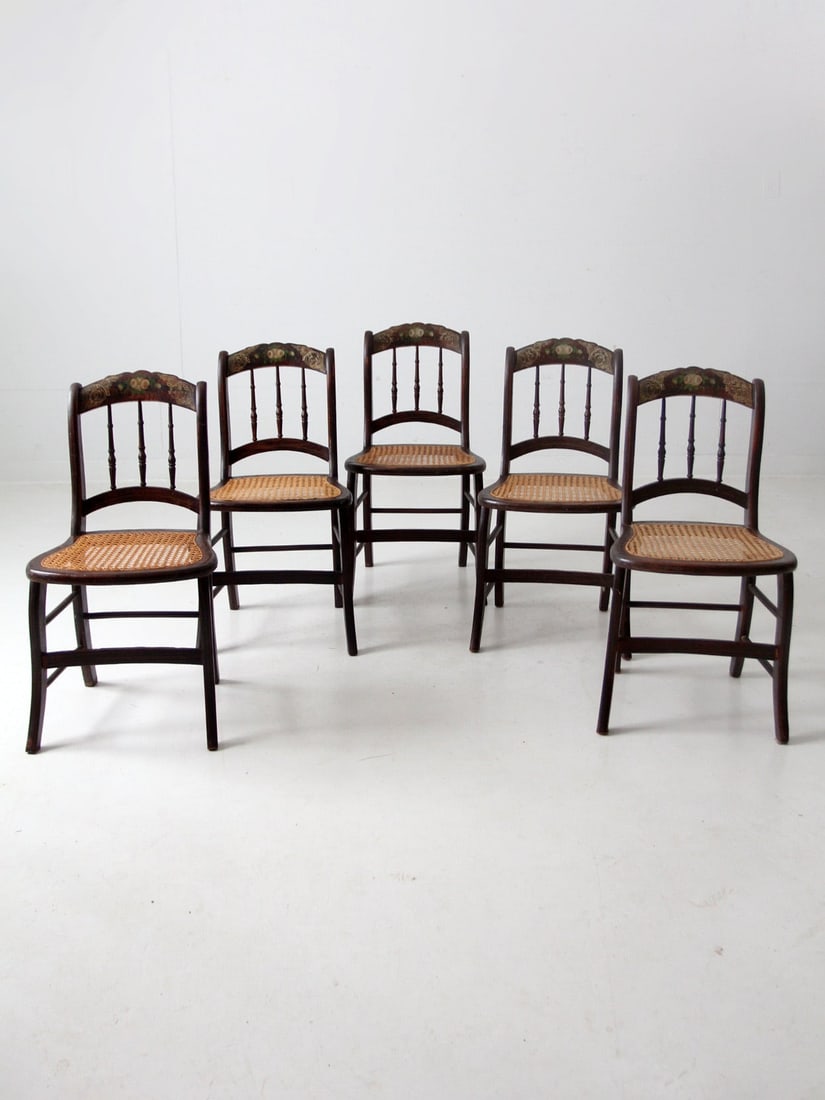 Set of 5 Antique Accent Chairs with Gold Stencil and Cane Seats: Set of 5 Antique Accent Chairs with Gold Stencil and Cane Seats This exquisite set of five antique accent chairs showcases a timeless design with gold stenciled and floral accents on the top back rail