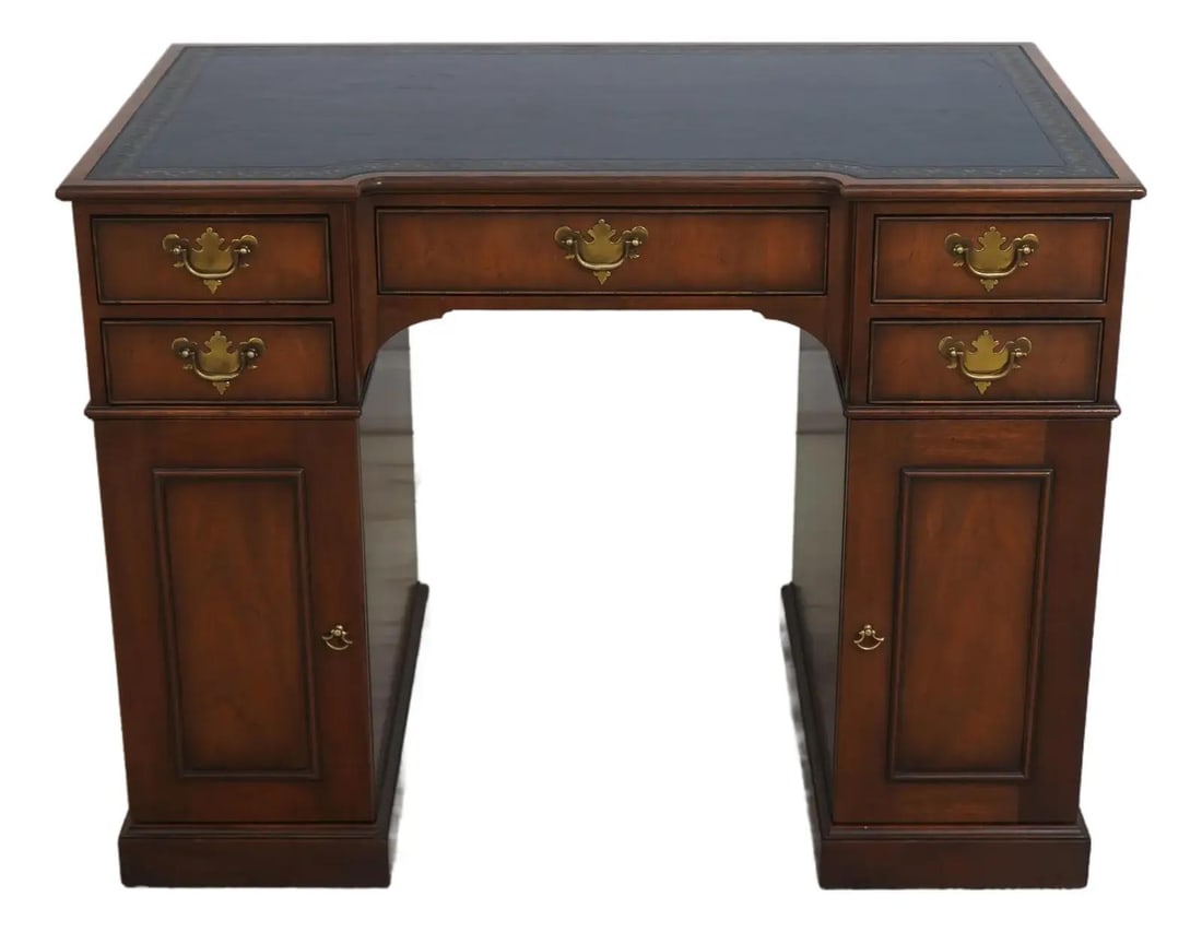 Kittinger Mahogany Desk with Black Tooled Leather Top: Kittinger Mahogany Desk with Black Tooled Leather Top This exquisite small English style writing desk features a quality black tooled leather top and is crafted from durable mahogany. The desk showcas
