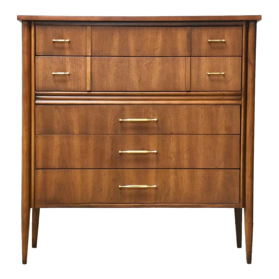 Mid Century Modern Walnut Brass Tall Dresser 40x19x41: Mid Century Modern Walnut Brass Tall Dresser 40x19x41 This mid-century modern tall dresser features a stunning design with cascading walnut drawer fronts complemented by polished brass drawer pulls. I