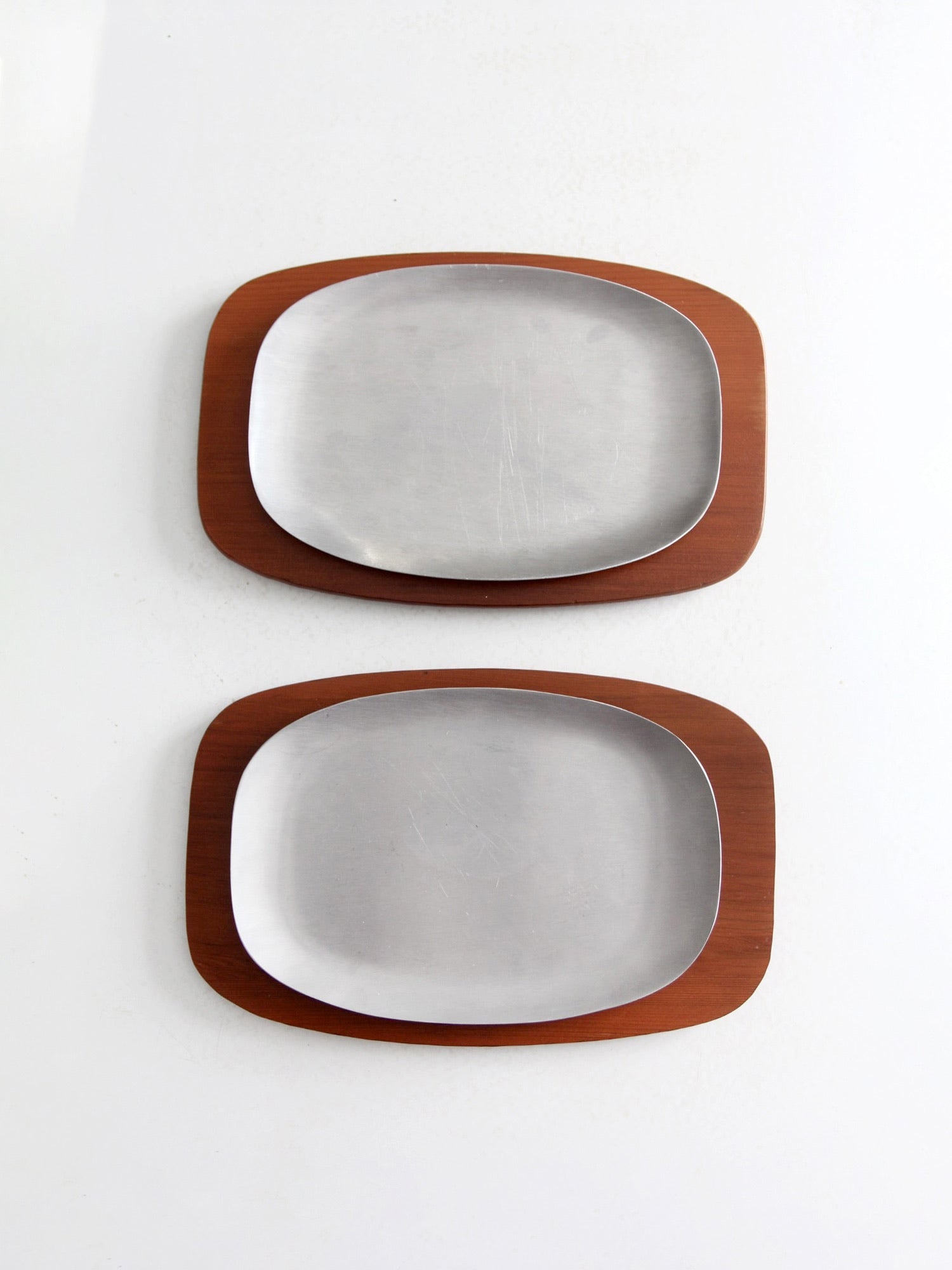 Mid Century Modern Sizzler Plates Set by AC Fabricators: Mid Century Modern Sizzler Plates Set by AC Fabricators Enhance your dining experience with this charming pair of mid-century modern sizzler plates from the 1960s, crafted by AC Fabricators. These sty
