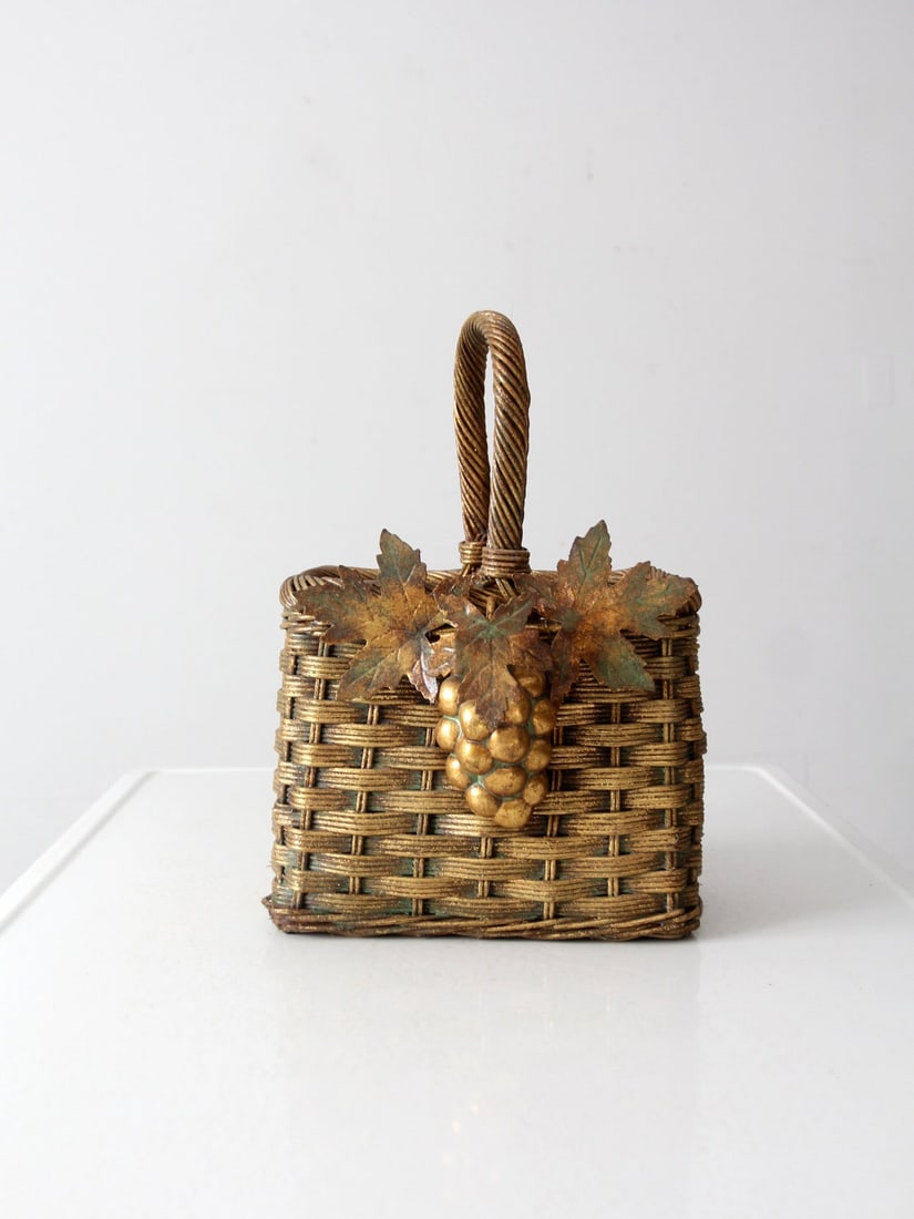 Vintage Gold Wicker Basket with Grape Leaf Design 15 Inch: Vintage Gold Wicker Basket with Grape Leaf Design 15 Inch This vintage gold wicker basket features a charming painted finish adorned with decorative grape and leaf motifs. It showcases a classic desig