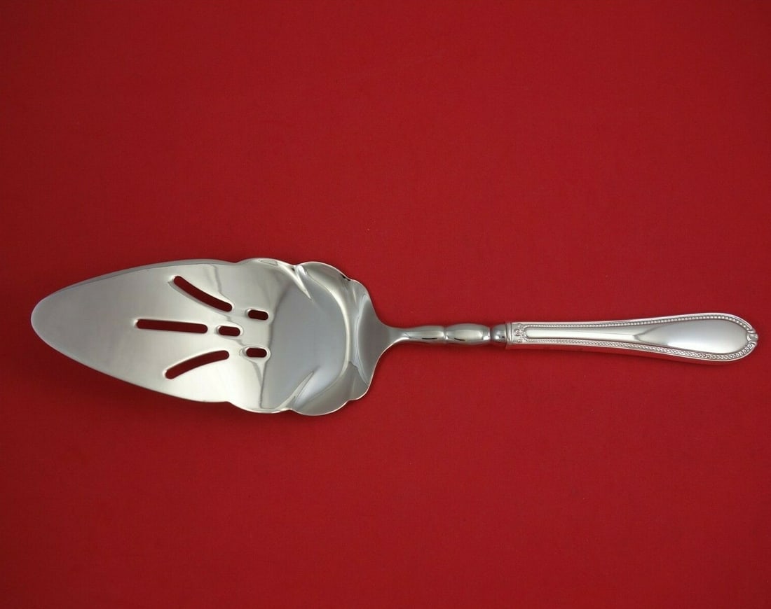 Tuttle Triumph Sterling Silver Large Scalloped Pie Server 12 3/4": Tuttle Triumph Sterling Silver Large Scalloped Pie Server 12 3/4" This exquisite Triumph pie server by Tuttle is crafted from high-quality sterling silver, featuring a hollow handle and a stainless st