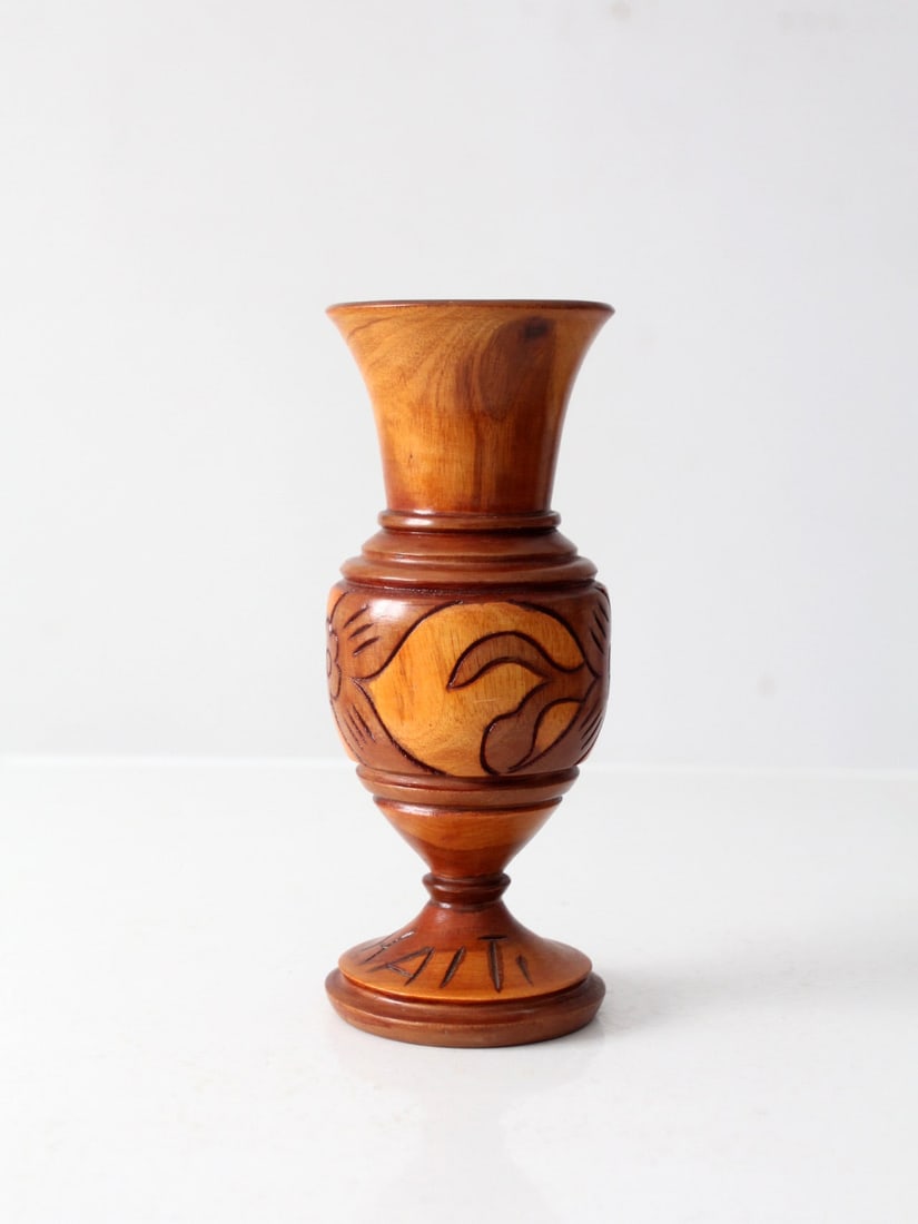 Mid-Century Haitian Hand-Carved Wooden Vase with Floral Design: Mid-Century Haitian Hand-Carved Wooden Vase with Floral Design This mid-century Haitian wooden vase showcases a graceful silhouette adorned with a hand-carved floral design that elegantly wraps around