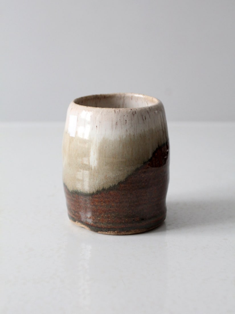 Organic Vintage Studio Pottery Vase Earth-Tone Glaze 4.75 Inch: Organic Vintage Studio Pottery Vase Earth-Tone Glaze 4.75 Inch This vintage studio pottery vase showcases an organic form with a rich earth-tone glaze that beautifully blends creamy whites, soft beige