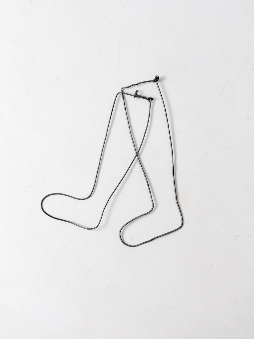 Pair of Antique Metal Sock Stretchers for Children: Pair of Antique Metal Sock Stretchers for Children This pair of antique children's wire sock stretchers showcases an open, linear design crafted from bent metal. Originally functional, these pieces no