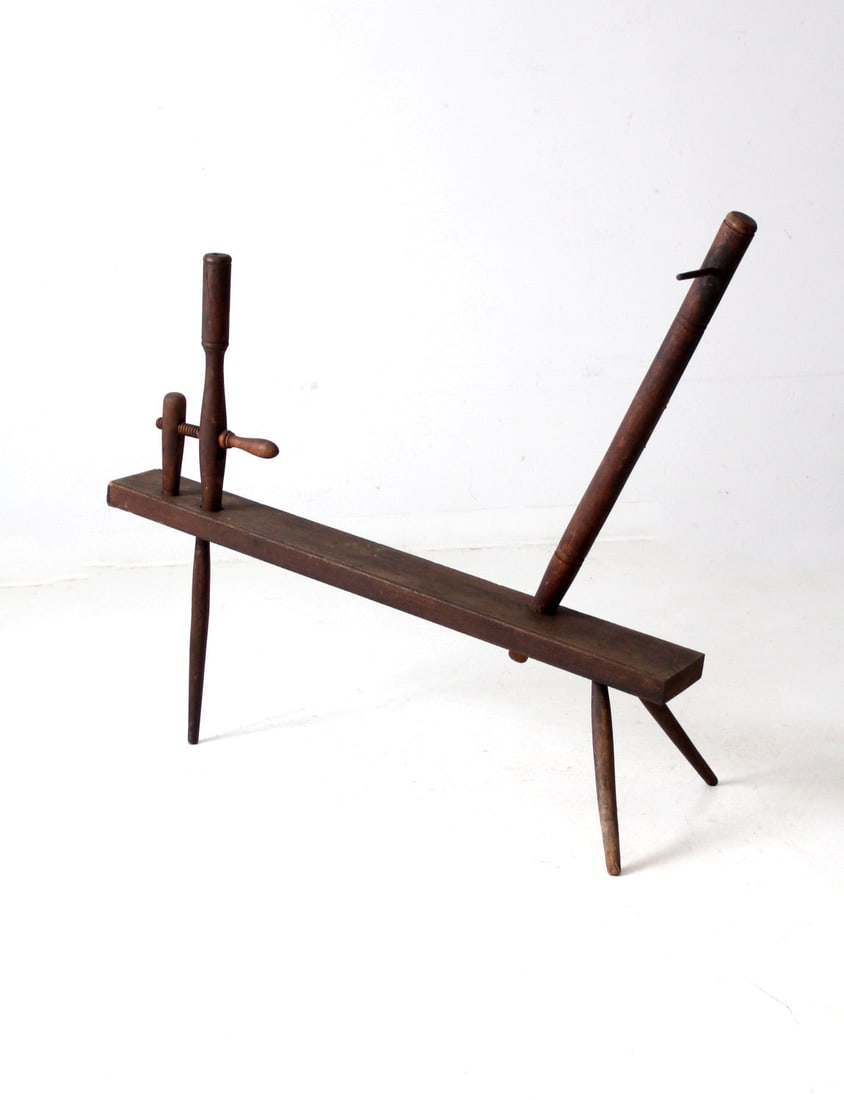 Rustic Antique Spinning Wheel Bench Functional Folk Art: Rustic Antique Spinning Wheel Bench Functional Folk Art Embrace the charm of history with this Antique Primitive Spinning Wheel Bench. This versatile piece of functional art features a beautifully cra