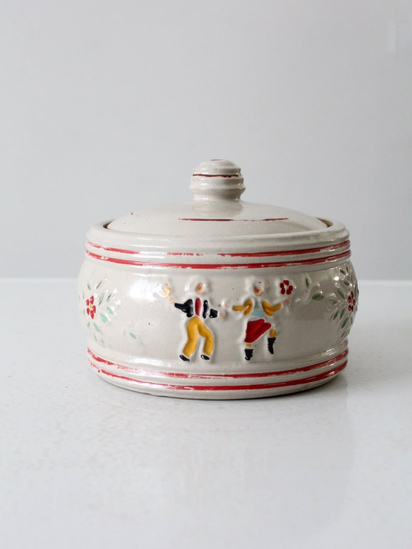 1940s Red Wing Pottery Incised Peasants Covered Jar: 1940s Red Wing Pottery Incised Peasants Covered Jar This 1940s vintage Red Wing Pottery jar, titled "Incised Peasants," showcases a beautiful ecru stoneware design. The covered bowl features a raised