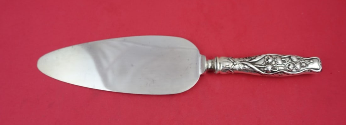 Whiting Sterling Silver Lily of the Valley Cake Server 9 3/4": Whiting Sterling Silver Lily of the Valley Cake Server 9 3/4" This exquisite cake server, crafted by Whiting in the renowned Lily of the Valley pattern, showcases a stunning design that dates back to