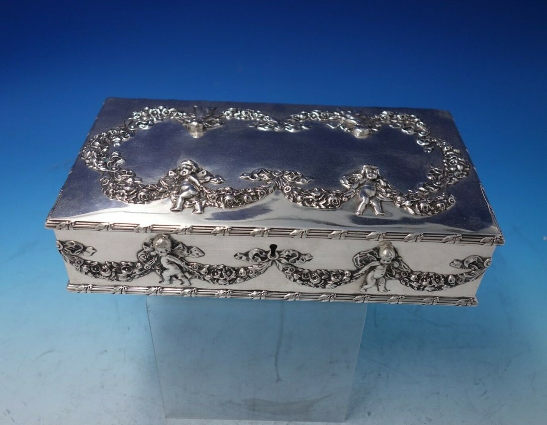 Howard Cupid Sterling Silver Cigar Box 9 x 5 Circa 1890: Howard Cupid Sterling Silver Cigar Box 9 x 5 Circa 1890 This stunning cigar box, crafted by Howard, showcases the classic Cupid pattern, featuring intricate cupids and swags of flowers. Made from ster