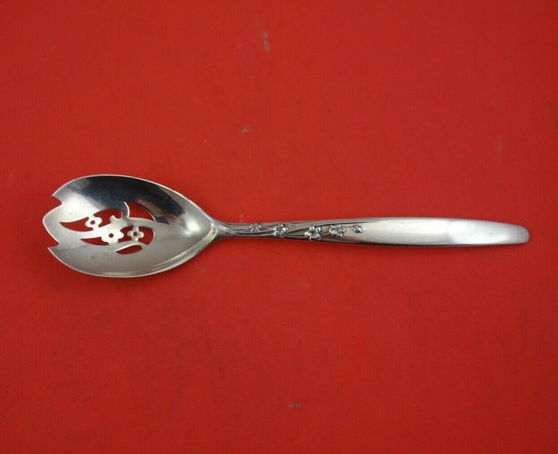 Lunt Summer Song Sterling Silver Pierced Serving Spoon 8 1/4": Lunt Summer Song Sterling Silver Pierced Serving Spoon 8 1/4" This exquisite serving spoon features the elegant Summer Song pattern by Lunt, crafted from high-quality sterling silver. Measuring 8 1/4