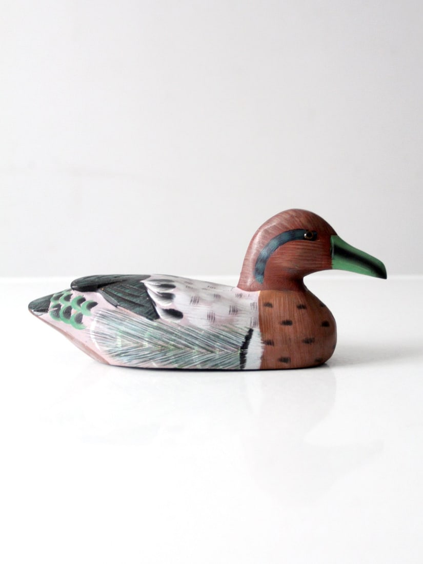 Hand-Painted Green-Winged Teal Wood Drake Sculpture with Glass Eyes: Hand-Painted Green-Winged Teal Wood Drake Sculpture with Glass Eyes This vintage hand-carved wooden duck represents a Green-winged Teal drake, featuring detailed hand-painted plumage in green and eart