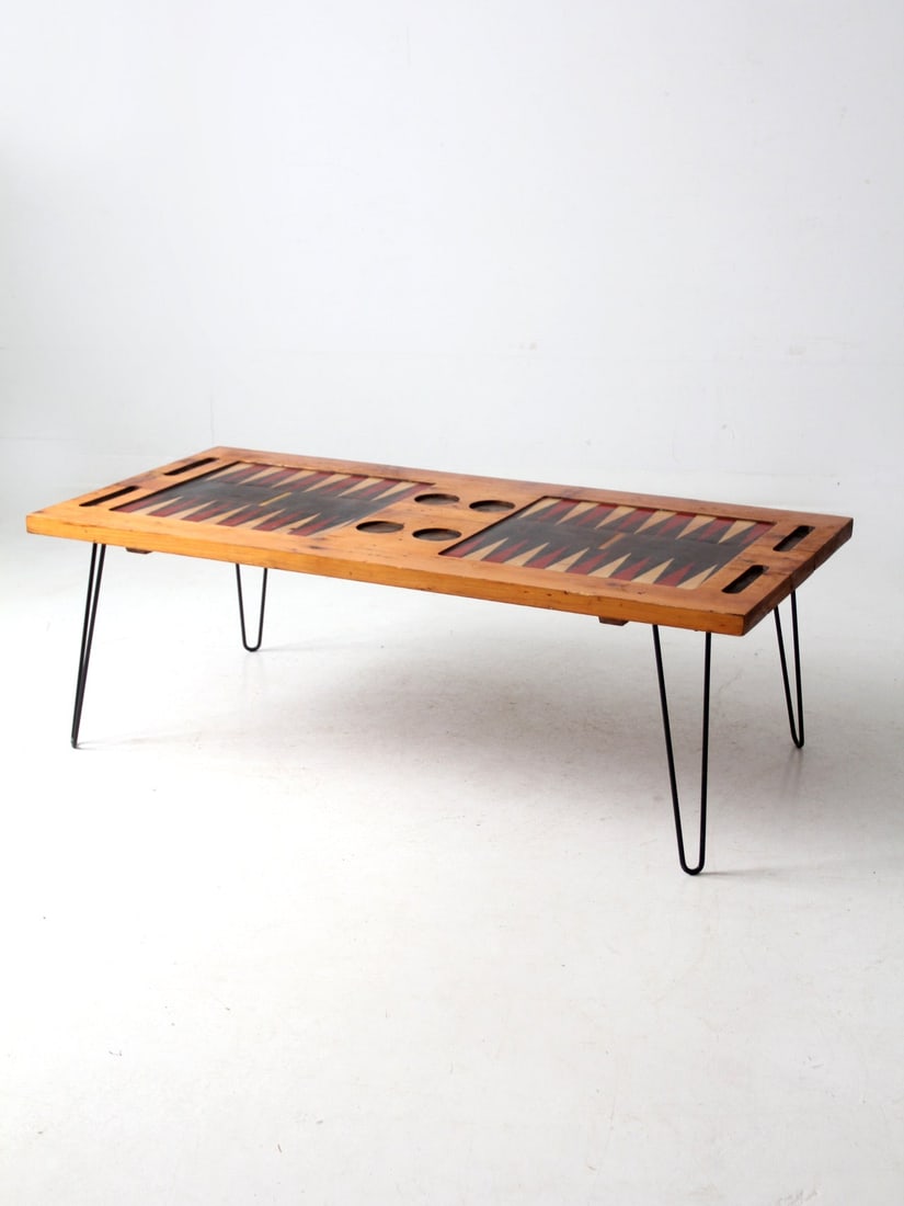 Vintage Mid Century Backgammon Coffee Table with Iron Legs: Vintage Mid Century Backgammon Coffee Table with Iron Legs This mid 20th century vintage backgammon game table doubles as a stylish coffee table. It features a beautifully crafted wooden top with two