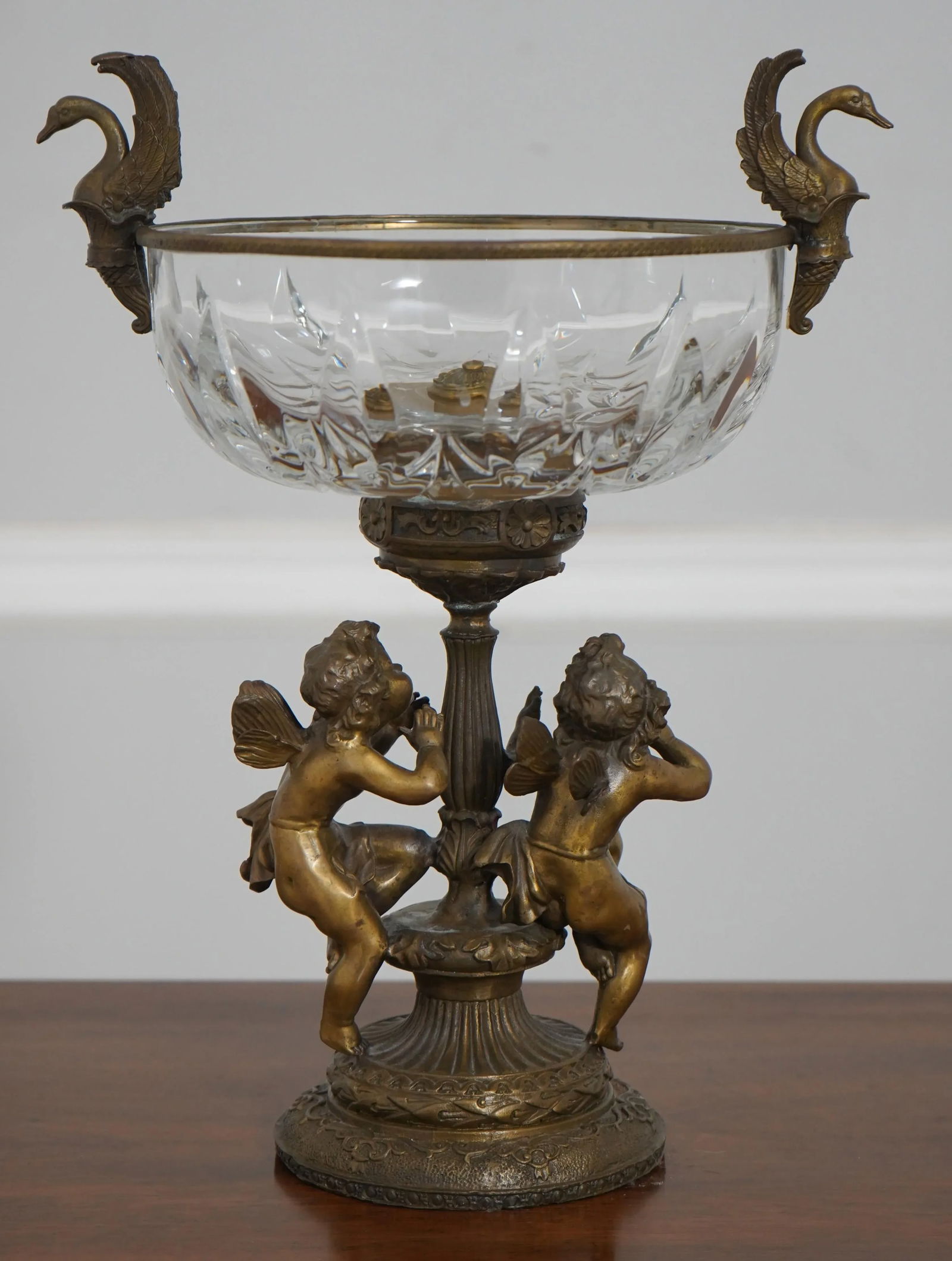 Victorian Bronze Cherub Base Crystal Compote Bowl 11 x 14: Victorian Bronze Cherub Base Crystal Compote Bowl 11 x 14 This exquisite Victorian Era compote bowl showcases a stunning crystal bowl supported by a beautifully crafted bronze base. The intricate desi