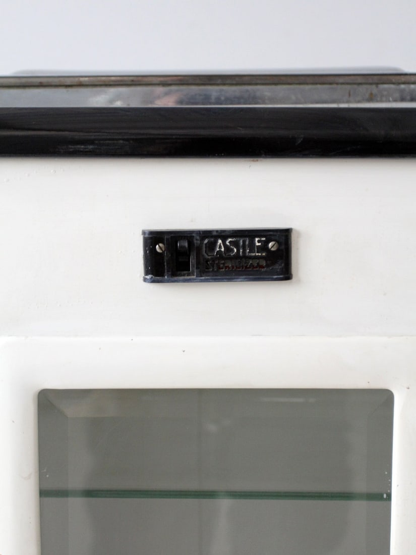 Vintage Castle Medical Sterilizer Type 95W White Black Enamel: Vintage Castle Medical Sterilizer Type 95W White Black Enamel This vintage Castle Sterilizer Type 95W showcases a classic white and black enamel finish, exuding a timeless industrial aesthetic. The in