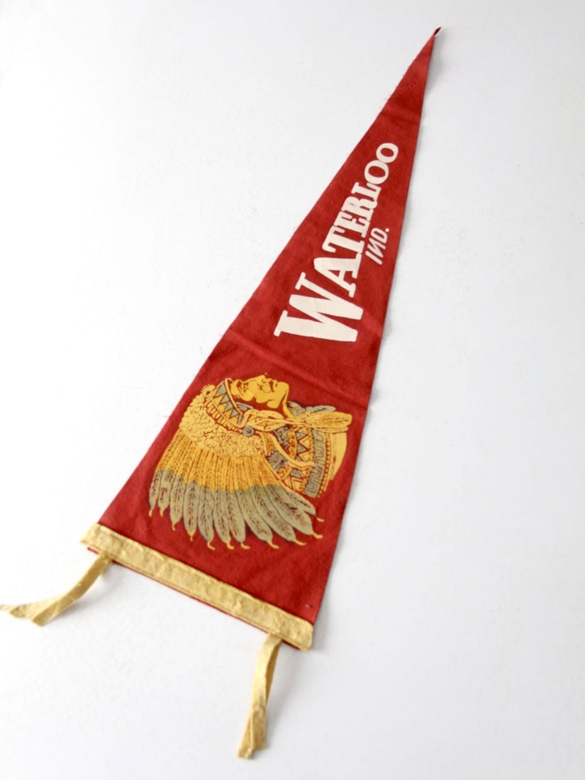 Vintage Waterloo Indiana Sports Pennant Red Felt 30 Inches: Vintage Waterloo Indiana Sports Pennant Red Felt 30 Inches This vintage sports pennant from Waterloo, Indiana showcases striking lettering and an Indian chief design in subtle colors against a classic