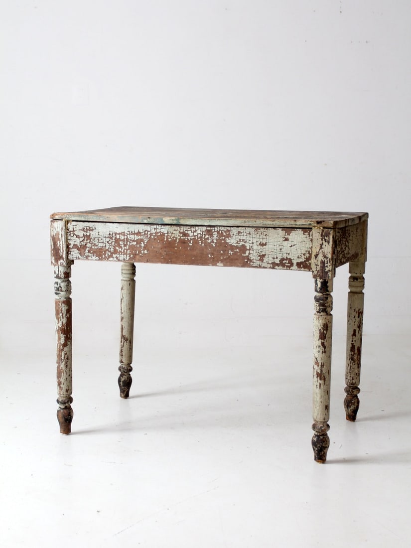 1800s Antique Primitive Table Rustic Blue Cream Charm: 1800s Antique Primitive Table Rustic Blue Cream Charm This antique primitive table from the 1800s showcases a delightful rustic charm with its chippy pale blue and cream paint. The three-plank tableto