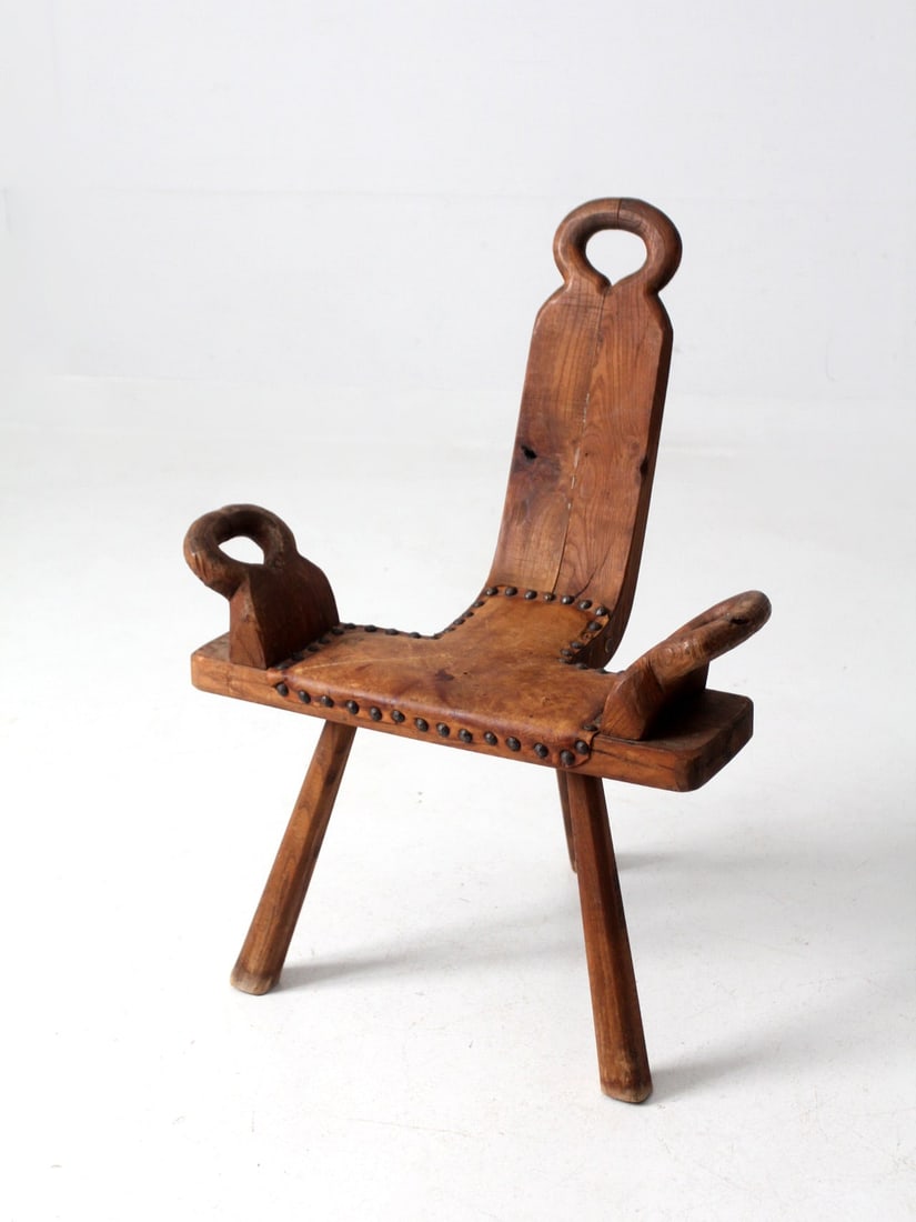 Mid-Century Spanish Brutalist Stool Rustic Wood Design with Leather Seat: Mid-Century Spanish Brutalist Stool Rustic Wood Design with Leather Seat This mid-century Spanish Brutalist stool features a unique rustic wood midwife's chair design. It includes a sloped back, conve