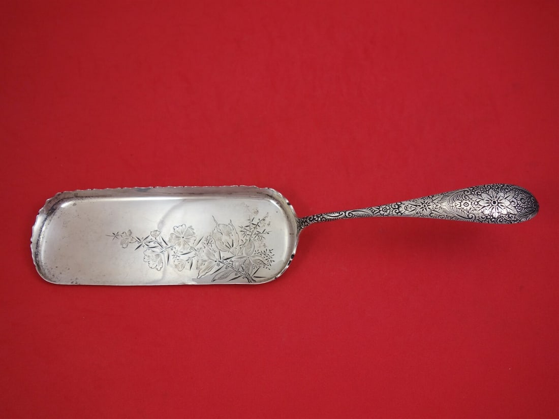 J E Caldwell Antique Engraved Sterling Silver Crumber 13 1/4": J E Caldwell Antique Engraved Sterling Silver Crumber 13 1/4" This exquisite crumber, crafted by J E Caldwell, features an intricate Antique Engraved pattern. Made of high-quality sterling silver, thi