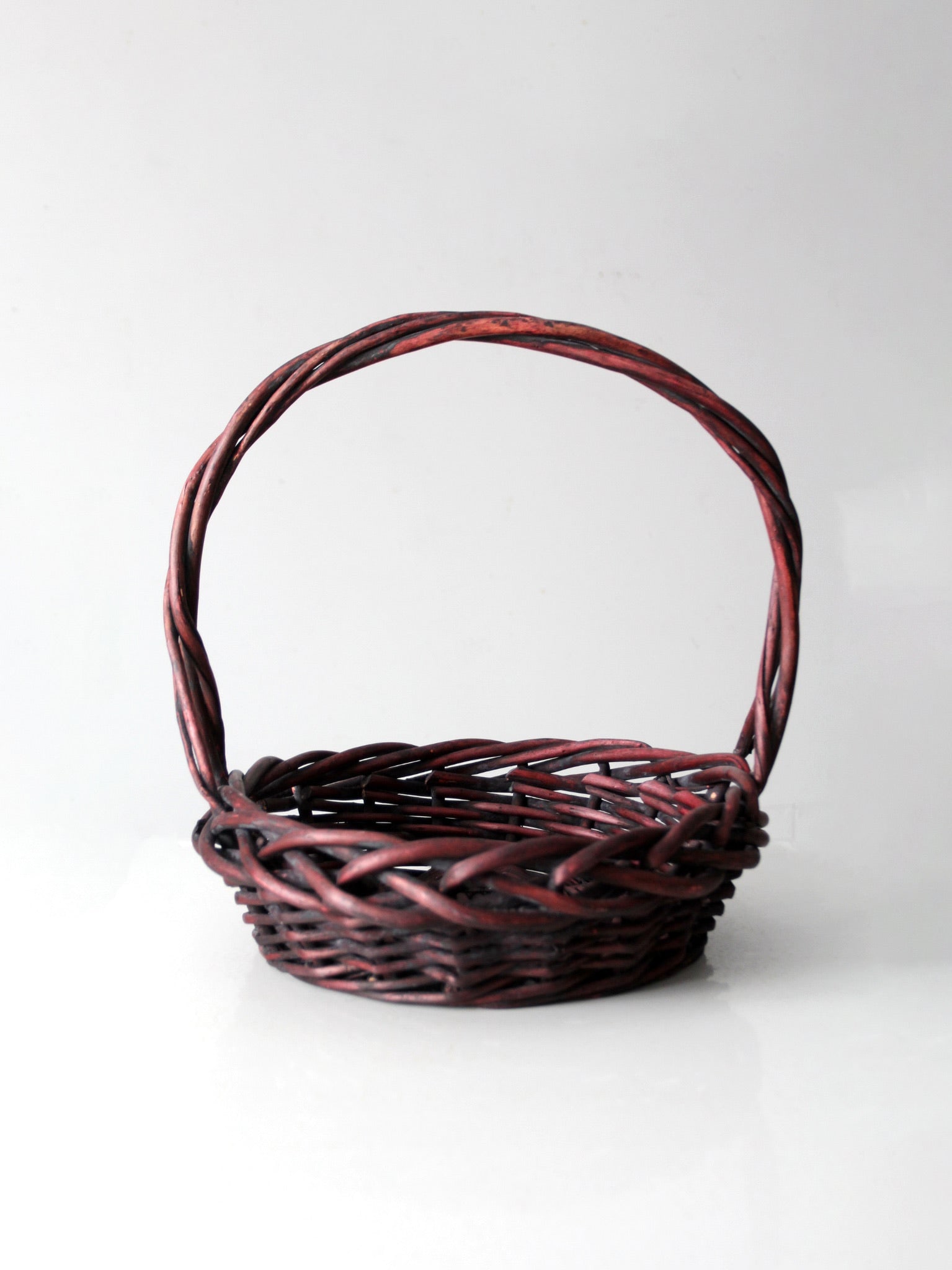 Vintage Burgundy Woven Wood Basket 17.5x17.5x16.5 Rustic Charm: Vintage Burgundy Woven Wood Basket 17.5x17.5x16.5 Rustic Charm This vintage woven wood basket features a rich burgundy hue, adding warmth and rustic charm to any space. Its tightly woven design makes