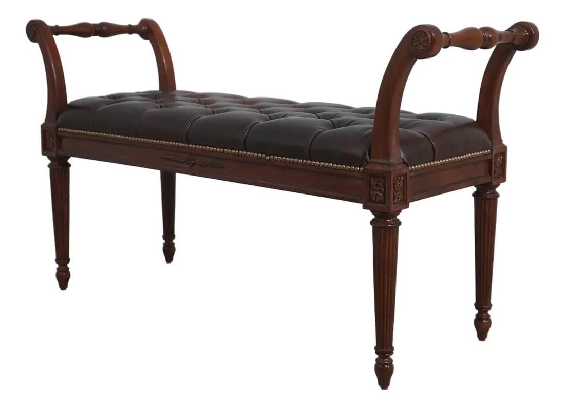 Brown Leather Upholstered Bench in Louis XVI Inspired Design: Brown Leather Upholstered Bench in Louis XVI Inspired Design This bench is crafted in the French Louis XVI style and features a tufted antique brown leather seat with tack head trim. The bench is fini