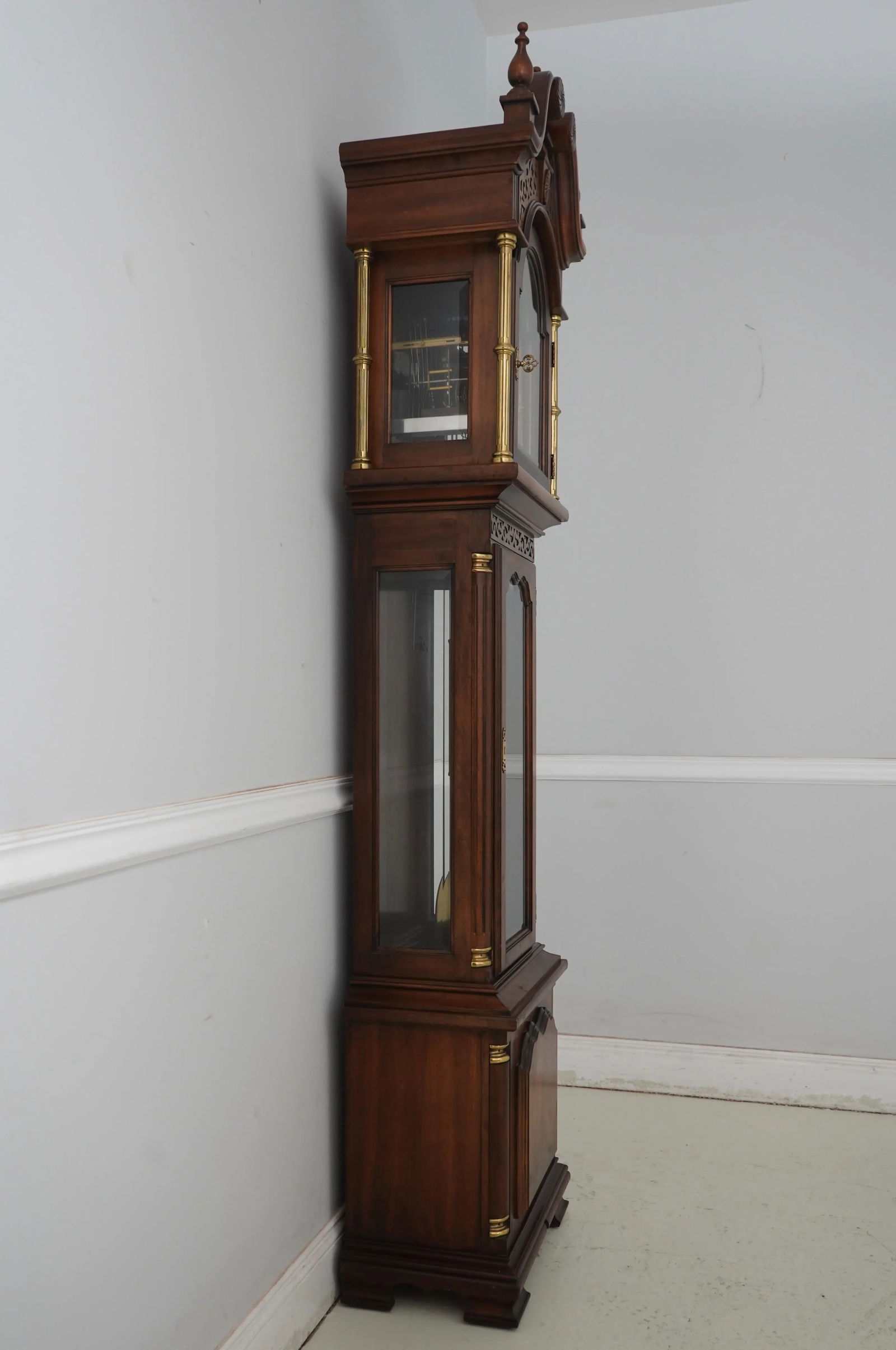 Ridgeway Cherry Tall Case Grandfather Clock with Beveled Glass and Moon Phase Dial: Ridgeway Cherry Tall Case Grandfather Clock with Beveled Glass and Moon Phase Dial This Ridgeway Cherry Tall Case Grandfather Clock is a stunning piece that showcases fine craftsmanship and exquisite