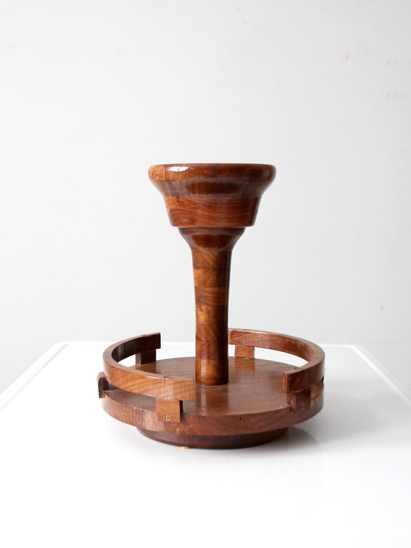 Mid-Century Wood Rotating Tabletop Centerpiece with Turned Column: Mid-Century Wood Rotating Tabletop Centerpiece with Turned Column This mid-century rotating tabletop stand features a sculptural turned center column, a flared bowl top, and a circular raised base. Th
