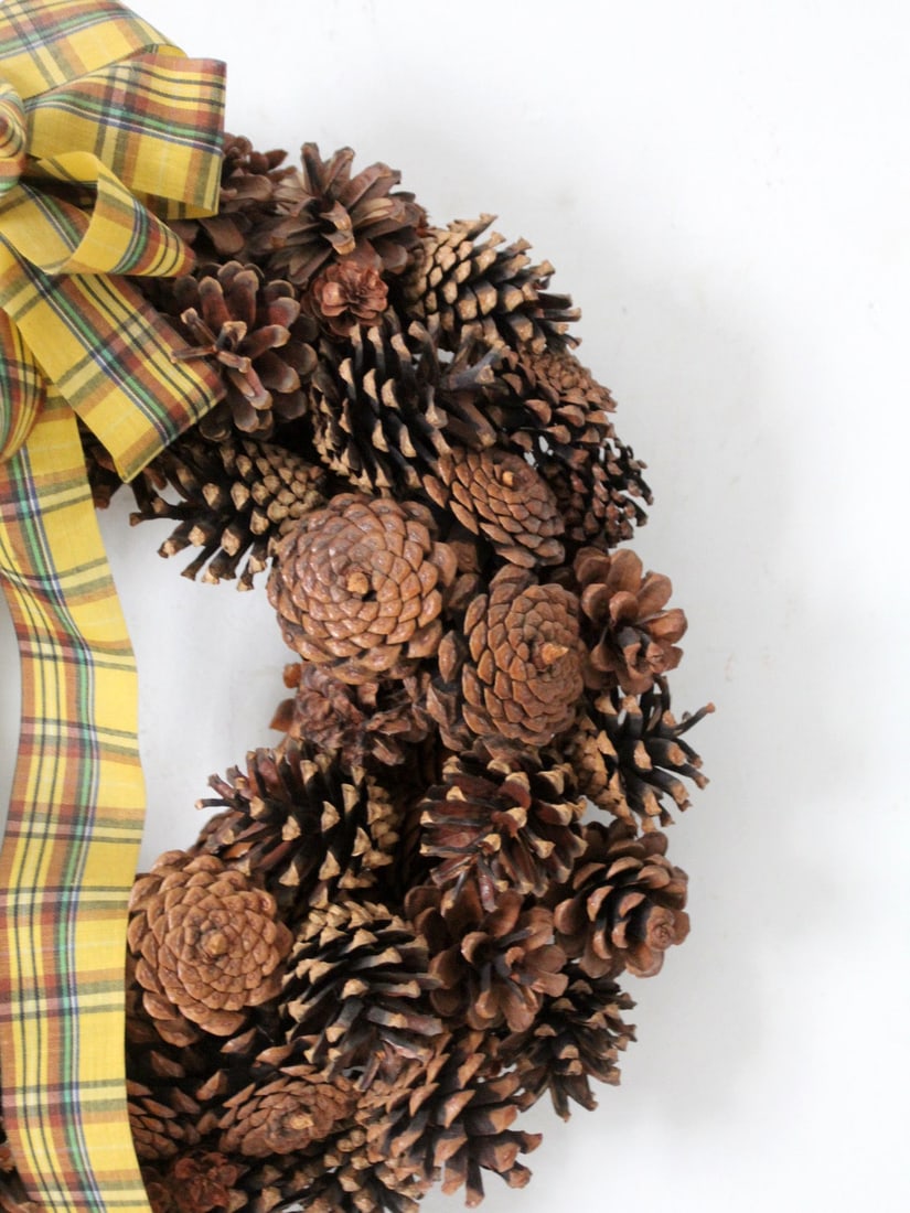 Vintage Pine Cone Wreath with Yellow Tartan Ribbon 14.5 Inch: Vintage Pine Cone Wreath with Yellow Tartan Ribbon 14.5 Inch This vintage pine cone wreath features a rich, textured composition of natural pine cones, showcasing an organic shape that complements var