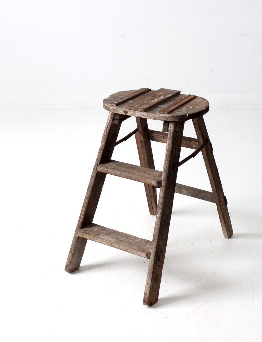 Charming Vintage Rustic Folding Step Ladder 23 inch: Charming Vintage Rustic Folding Step Ladder 23 inch This vintage folding step ladder features a charming rustic patina, showcasing its weathered wood and folk repairs that narrate a history of use. Id