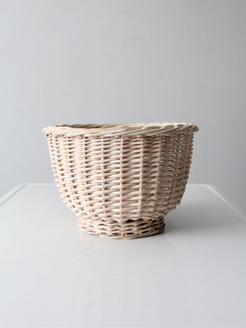 Vintage Cream Wicker Basket with Flared Silhouette 12.25 in: Vintage Cream Wicker Basket with Flared Silhouette 12.25 in Discover the charm of this vintage cream wicker basket, designed with an airy woven texture and a gracefully flared silhouette. The raised f