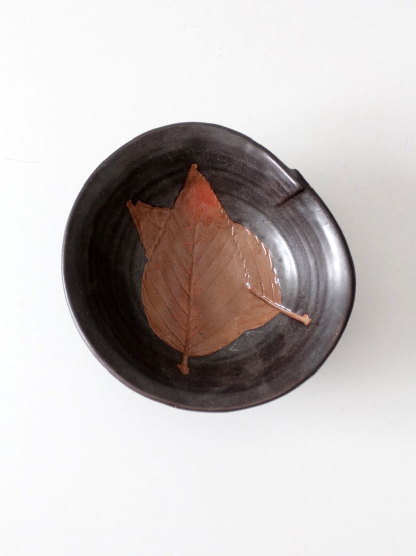 Handmade Vintage Studio Pottery Bowl with Leaf Motif: Handmade Vintage Studio Pottery Bowl with Leaf Motif This vintage studio pottery bowl is a handmade piece showcasing an impressed leaf motif in warm terracotta tones, beautifully contrasted by a deep