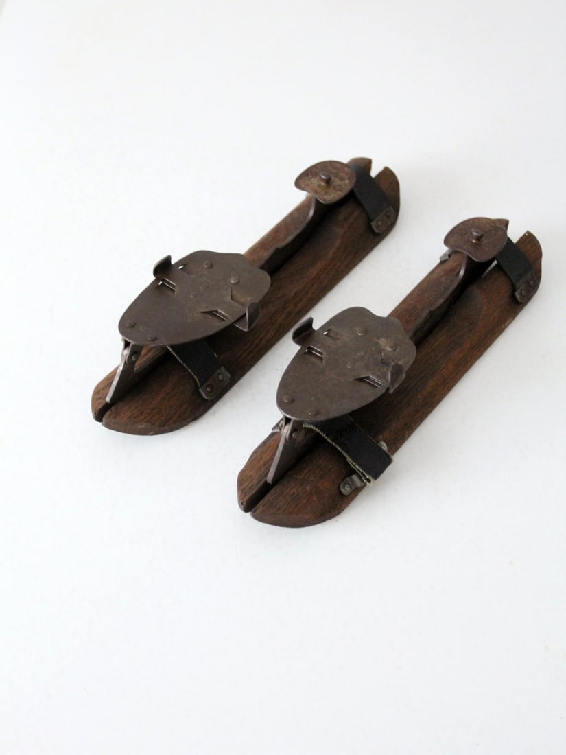 Antique Barney & Berry Ice Skates with Wooden Holders: Antique Barney & Berry Ice Skates with Wooden Holders This pair of antique Barney & Berry ice skates showcases a unique design with wooden blade holders and leather straps for secure fitting. They are