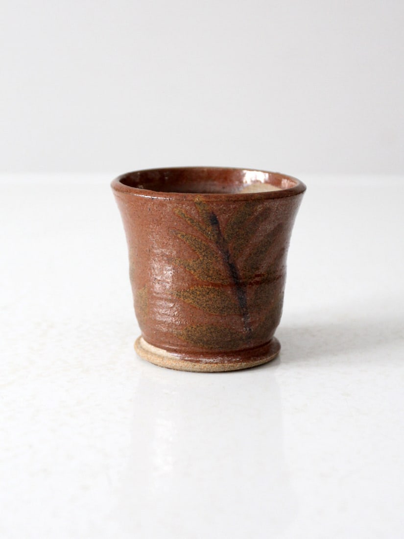 Handmade Vintage Stoneware Planter Vase with Leaf Motif: Handmade Vintage Stoneware Planter Vase with Leaf Motif This vintage handmade stoneware planter features a subtle leaf motif and a warm brown glaze, making it a perfect addition to modern rustic and o
