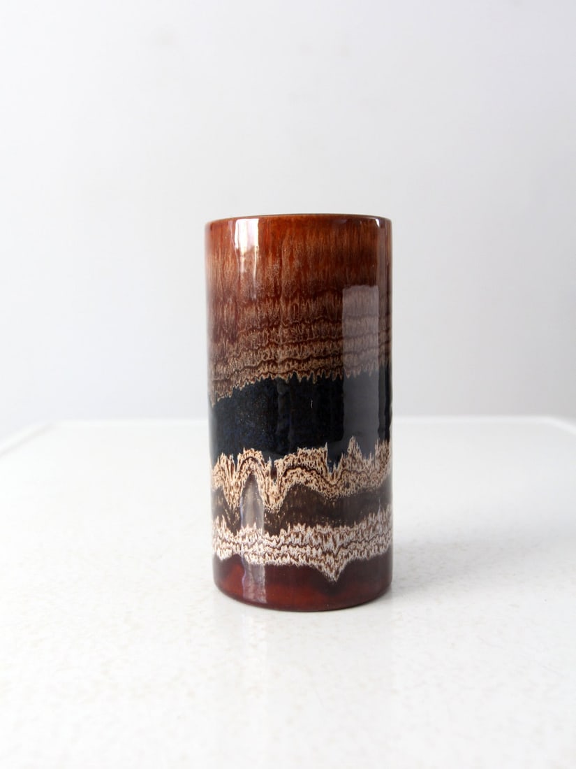 Mid-Century Royal Haegar Drip Glaze Vase 7 Inch: Mid-Century Royal Haegar Drip Glaze Vase 7 Inch This mid-century Royal Haegar vase showcases a classic cylindrical design with warm earthen tones enhanced by a unique drip style glaze. The vase is a b