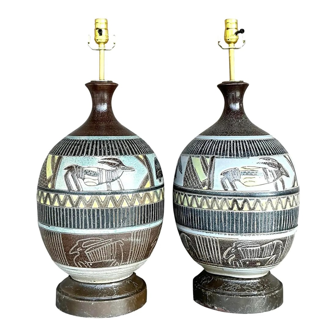 Vintage Boho Tribal Lamps Pair with Hand-Carved Ceramic Bases: Vintage Boho Tribal Lamps Pair with Hand-Carved Ceramic Bases Enhance your living space with this striking pair of vintage boho tribal lamps. Each lamp features a ceramic base adorned with bold, hand-
