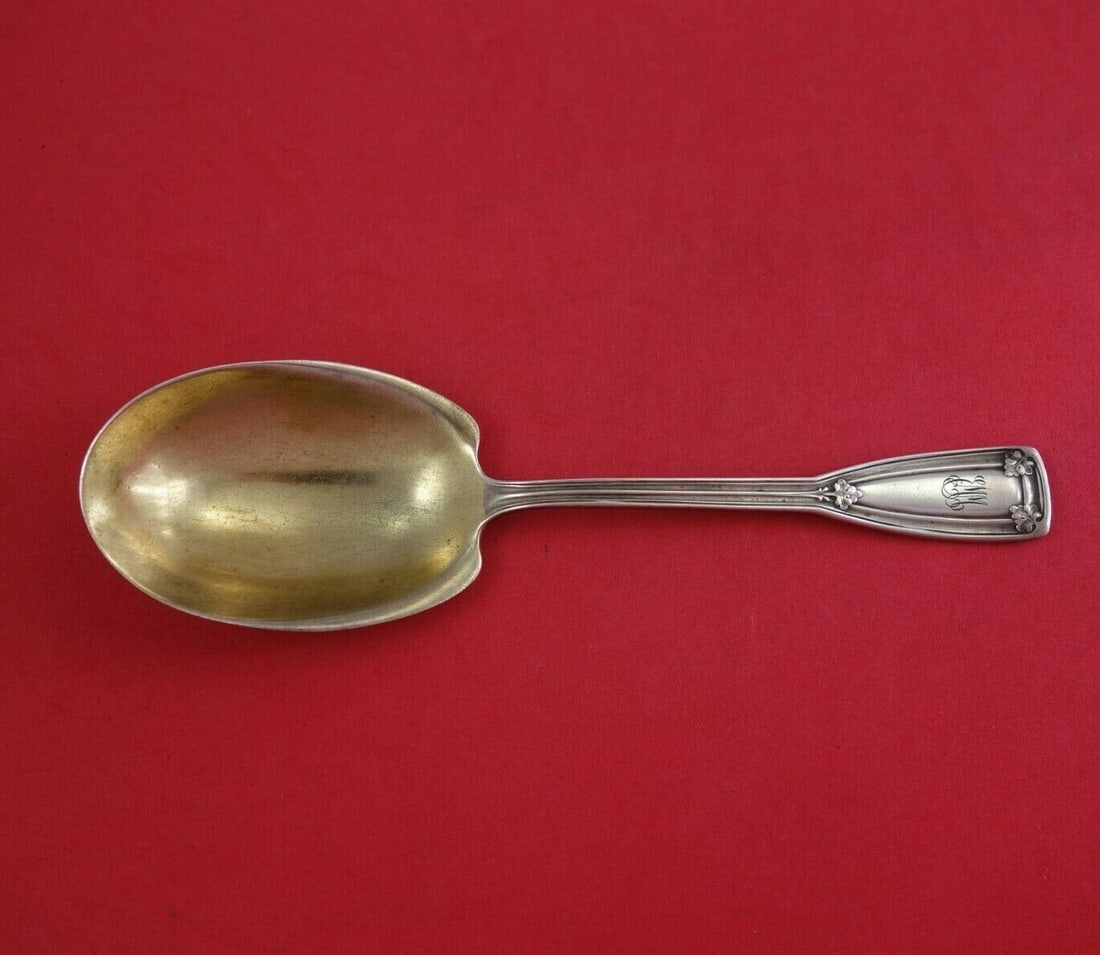 Tiffany & Co Saint Dunstan Sterling Silver Preserve Spoon 7 5/8": Tiffany & Co Saint Dunstan Sterling Silver Preserve Spoon 7 5/8" This exquisite preserve spoon is a stunning piece from Tiffany & Co., crafted in sterling silver with a gold wash finish. The spoon fea