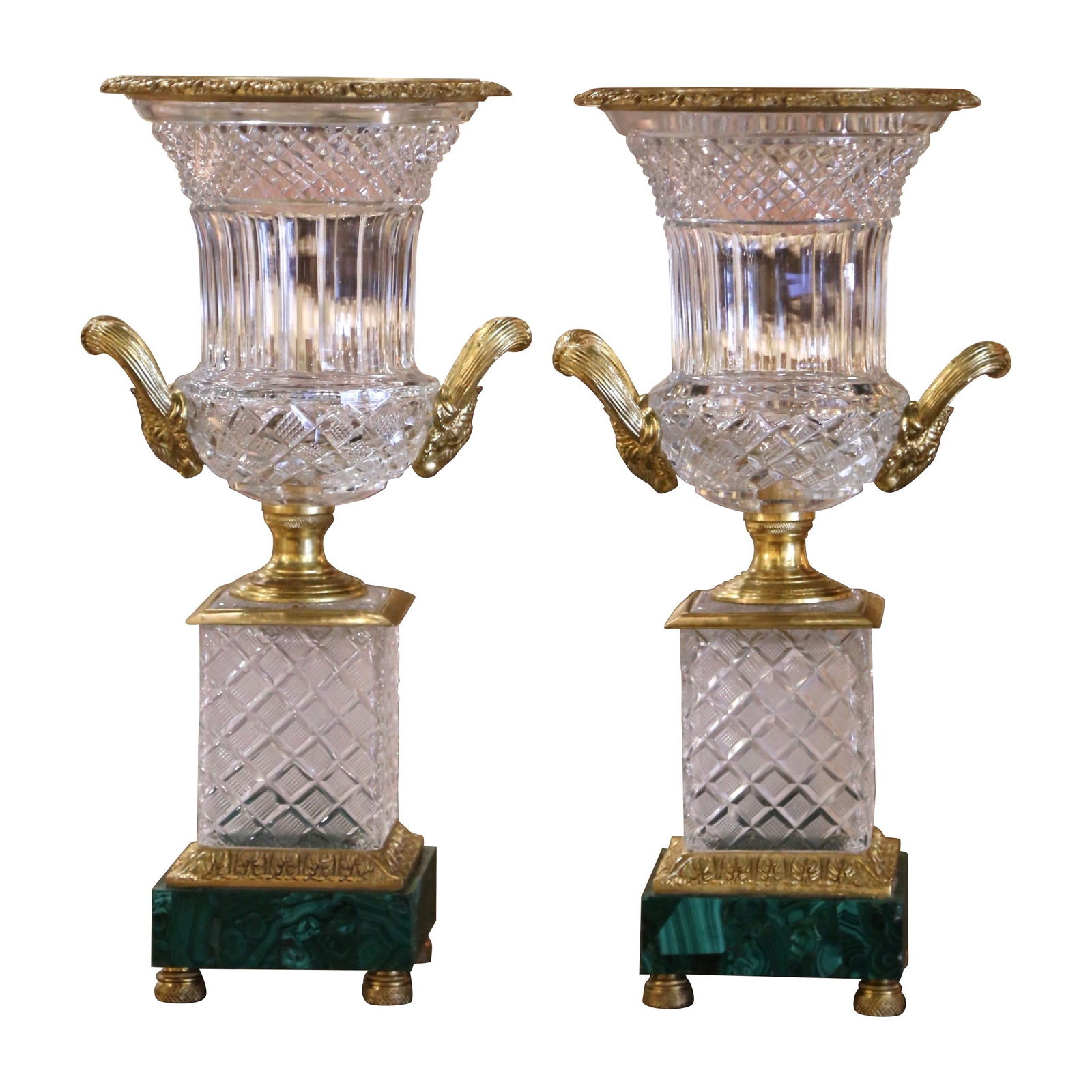 Set of 2 Neoclassical Baccarat Style Urns with Gilt Bronze and Malachite Bases: Set of 2 Neoclassical Baccarat Style Urns with Gilt Bronze and Malachite Bases This exquisite pair of neoclassical urns brings an elegant touch to any decor. Crafted in France around 1930, each urn fe