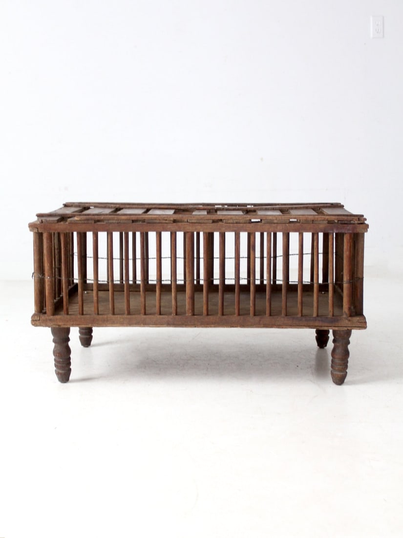 Rustic Antique Farm Crate Coffee Table with Spindle Sides: Rustic Antique Farm Crate Coffee Table with Spindle Sides This antique primitive farm crate features spindle sides, a slatted top, and turned legs, exuding a warm patina that adds character to any spa