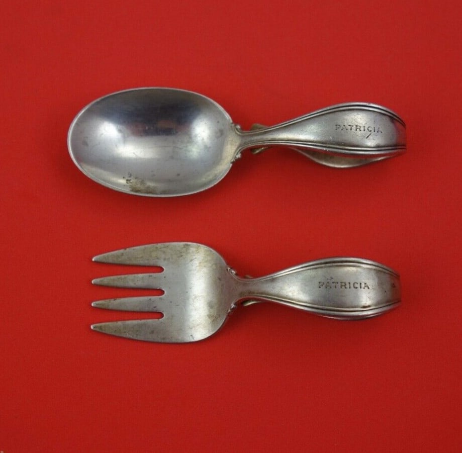 Tiffany & Co Sterling Silver Baby Set 2-Piece Monogrammed 3 3/4": Tiffany & Co Sterling Silver Baby Set 2-Piece Monogrammed 3 3/4" This exquisite 2-piece baby set from Tiffany & Co. is crafted in high-quality sterling silver. The set features a bent handle design, m