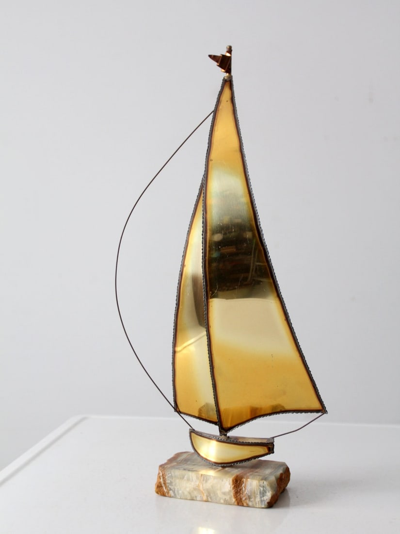 Mid Century Jere Demott Brass Sailboat Sculpture with Quartz Base: Mid Century Jere Demott Brass Sailboat Sculpture with Quartz Base This striking Mid Century Demont brass sailboat sculpture is a captivating piece of art that showcases patinated brass sheets and copp
