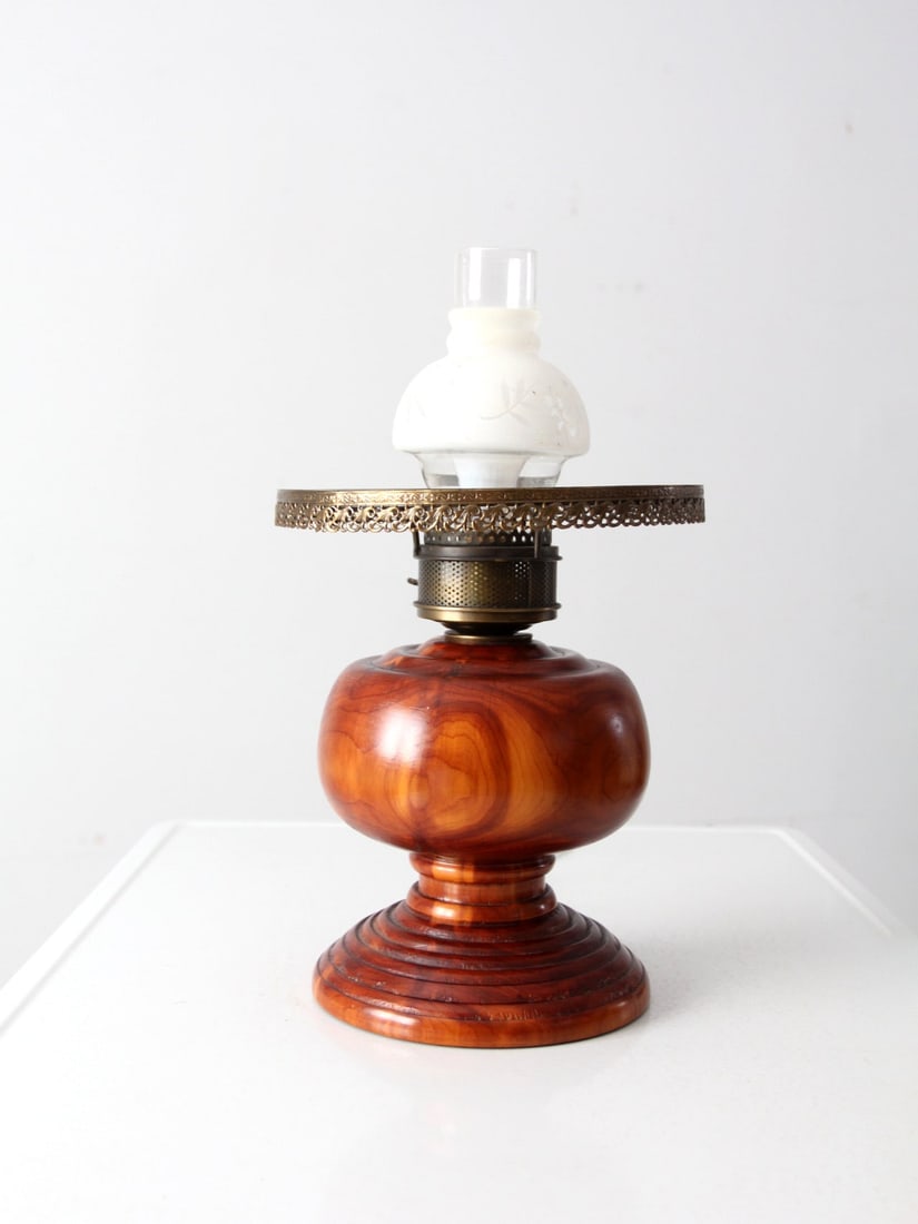 Electrified Antique Oil Lamp with Wood Base and Floral Shade: Electrified Antique Oil Lamp with Wood Base and Floral Shade This electrified antique oil lamp showcases a beautiful turned wood base complemented by a decorative brass top ring and a floral frosted h
