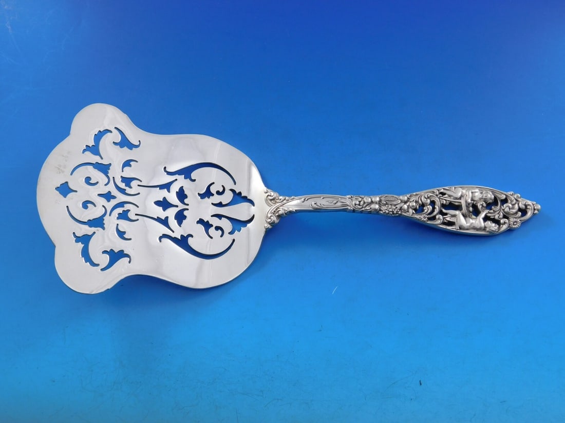 Dominick & Haff Labors of Cupid Sterling Silver Asparagus Server 9.5 inches: Dominick & Haff Labors of Cupid Sterling Silver Asparagus Server 9.5 inches Discover the exquisite craftsmanship of the Labors of Cupid Asparagus Server, a striking piece by Dominick & Haff. This ster