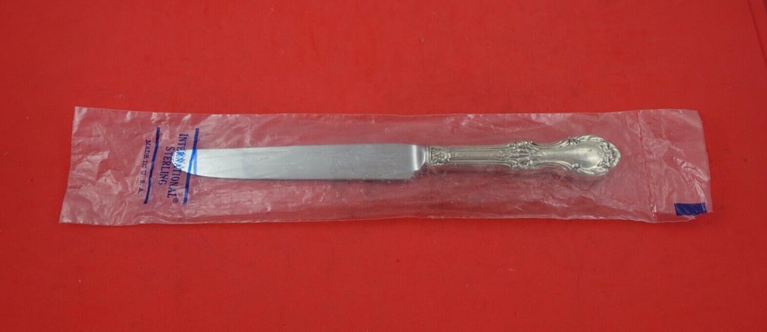 International Sterling Silver Dinner Knife Wild Rose 9 5/8 Modern: International Sterling Silver Dinner Knife Wild Rose 9 5/8 Modern This exquisite dinner knife features the elegant Wild Rose pattern by International Sterling. Crafted with a sterling silver hollow ha