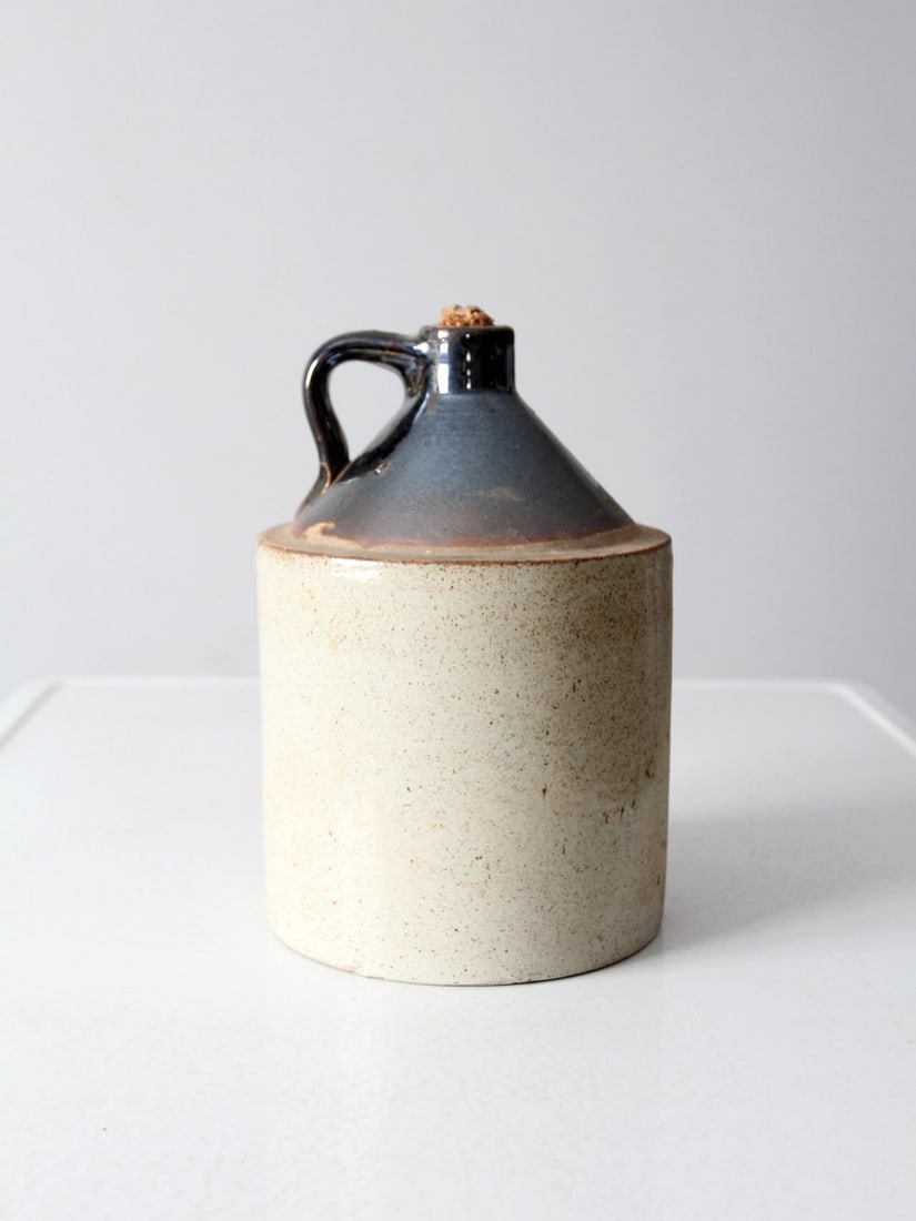 Vintage 2 Gallon Antique Stoneware Crock Jug with Cork: Vintage 2 Gallon Antique Stoneware Crock Jug with Cork This antique stoneware crock jug showcases a beautifully crafted design with a brown slip top and a natural tone glazed base. With a capacity of