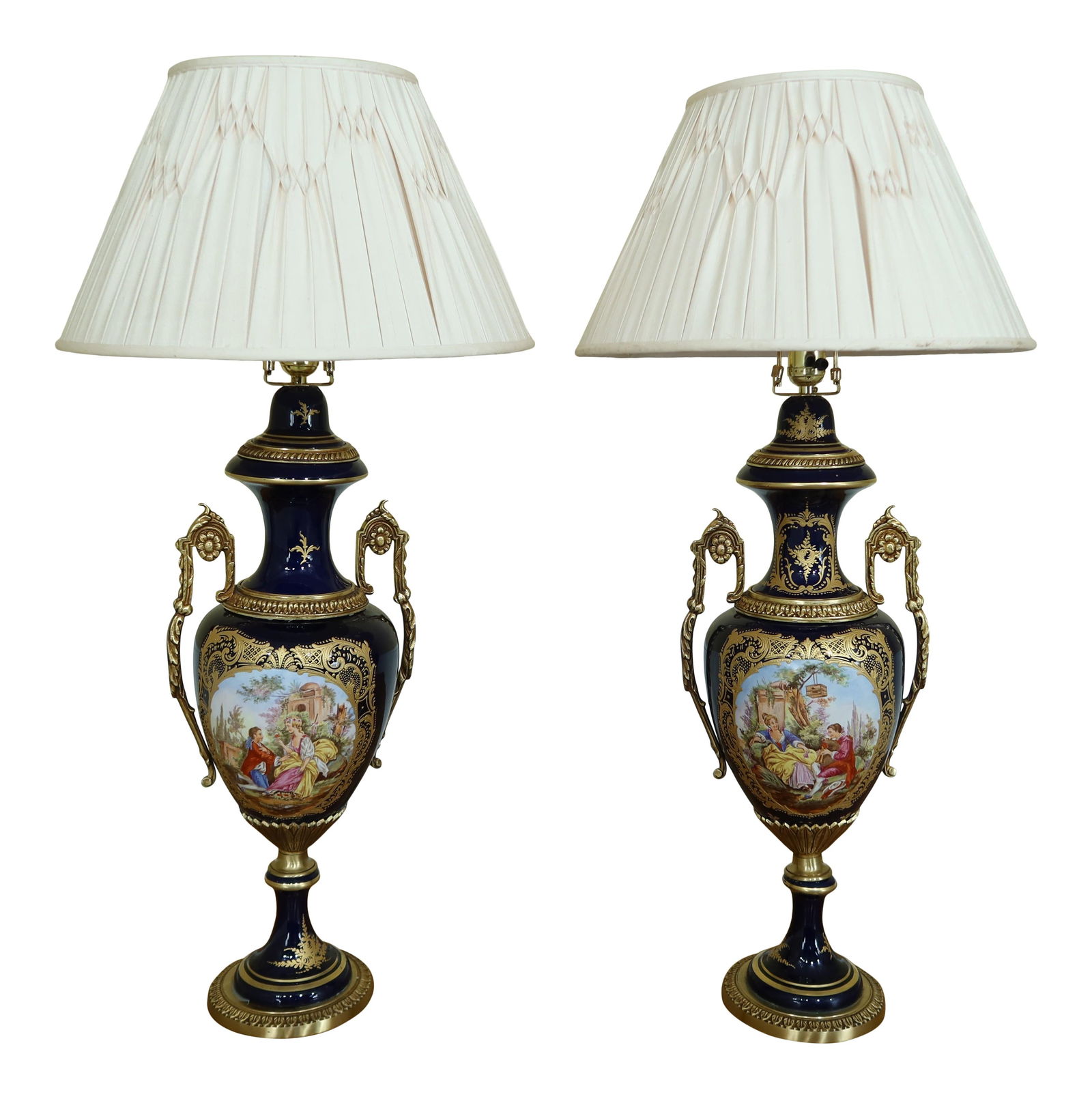 Stunning Pair of Seures Porcelain Table Lamps with Bronze Accents: Stunning Pair of Seures Porcelain Table Lamps with Bronze Accents This impressive pair of Seures porcelain table lamps features stunning painted French scenes on the front, showcasing intricate artist