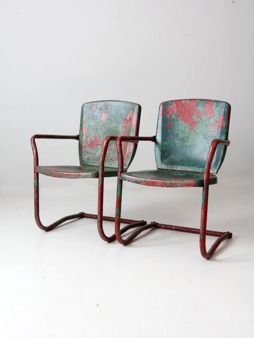 Vintage Mid-Century Metal Patio Chairs Pair Green Red Paint: Vintage Mid-Century Metal Patio Chairs Pair Green Red Paint This pair of mid-century patio chairs features durable metal construction with bouncer frames and perforated seats and backs, displaying a b